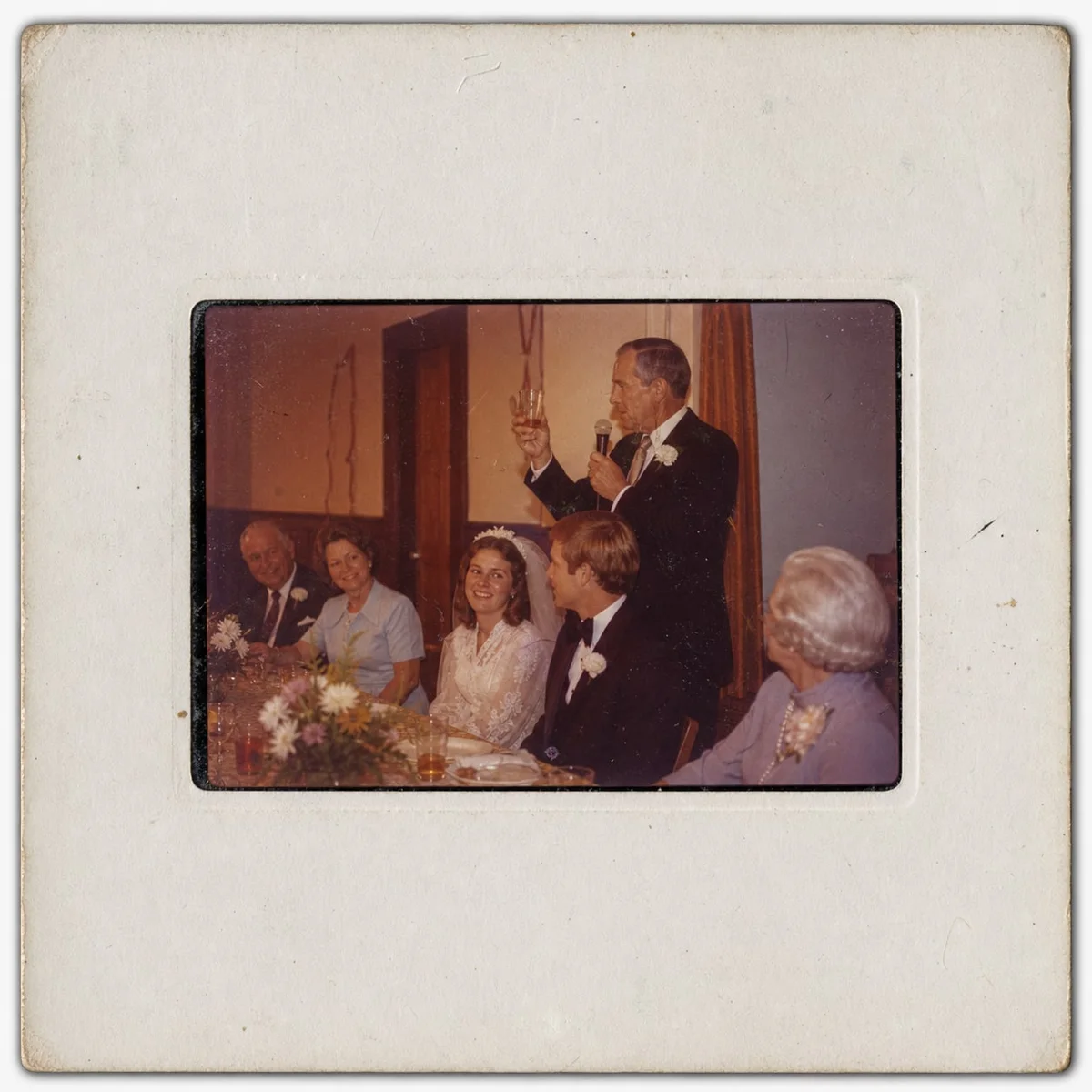 Mounted 35mm slide showing a faded wedding reception toast.