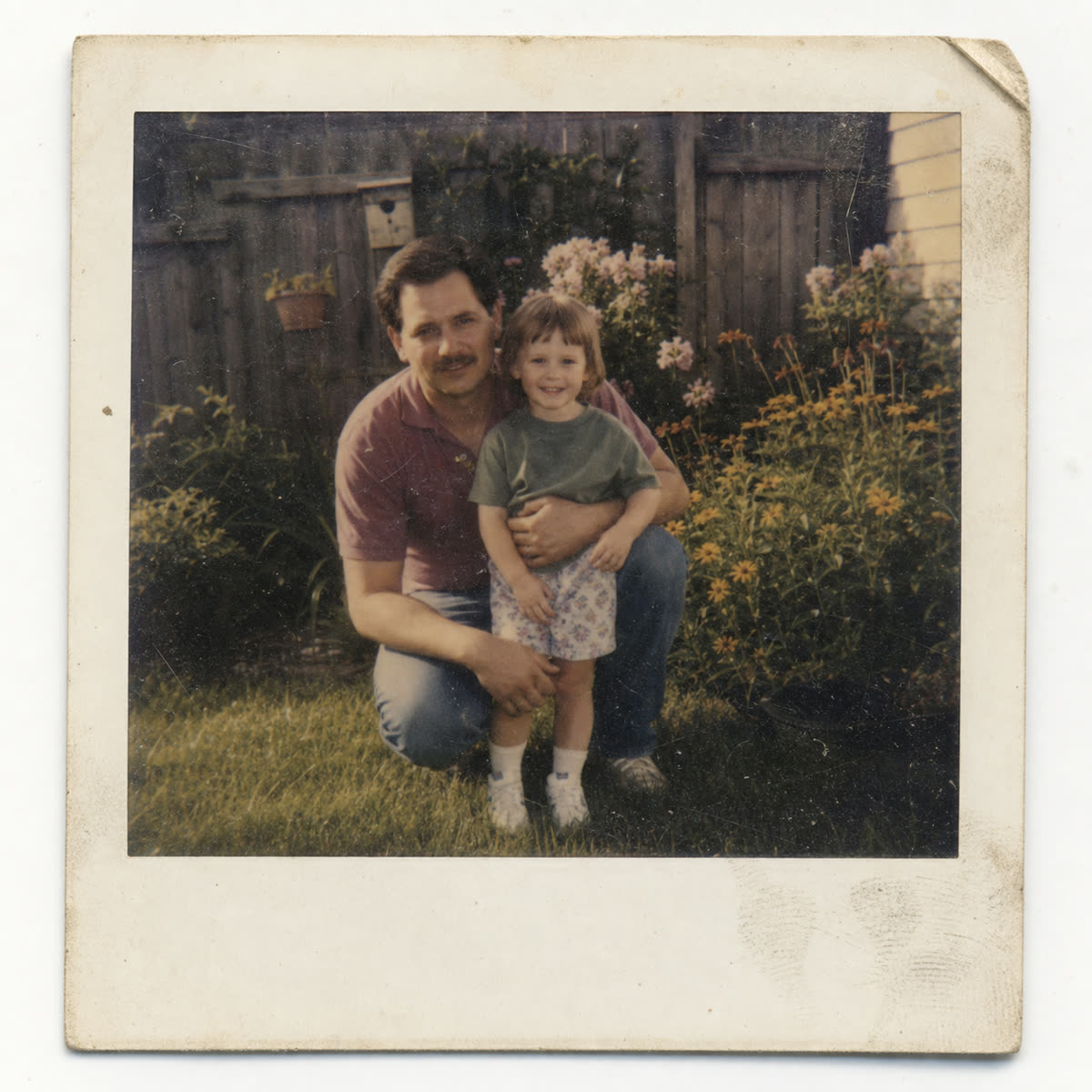 Damp-stored faded garden family photo restored with PhotoScanRestore before