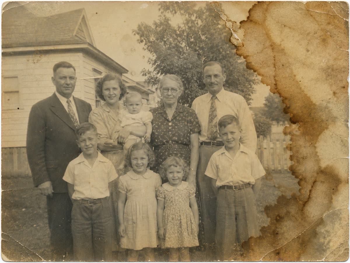Heavily water stained old family photo restored with PhotoScanRestore before