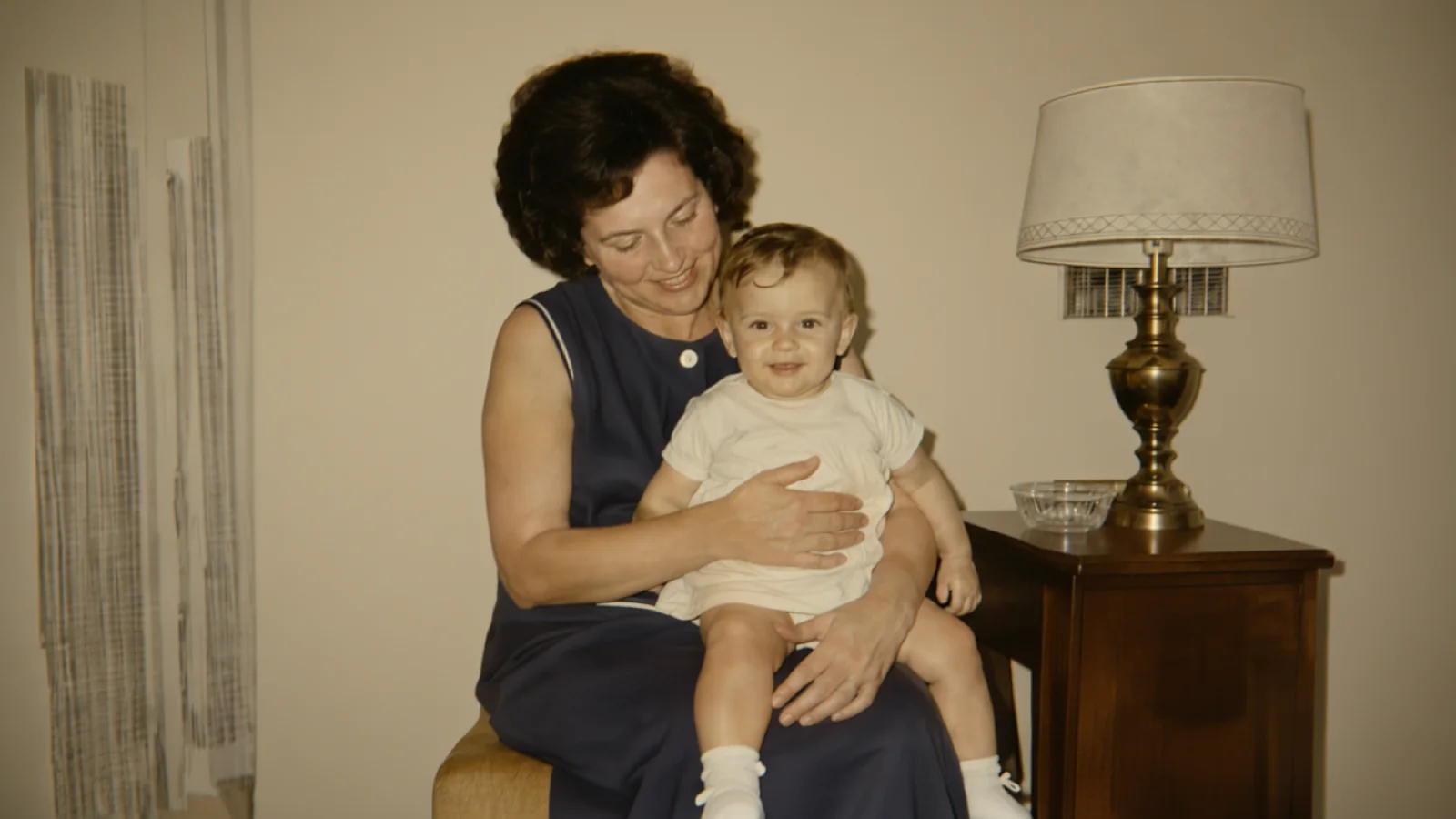 Restored family room portrait with repaired creases, cleaner color, and clearer faces.